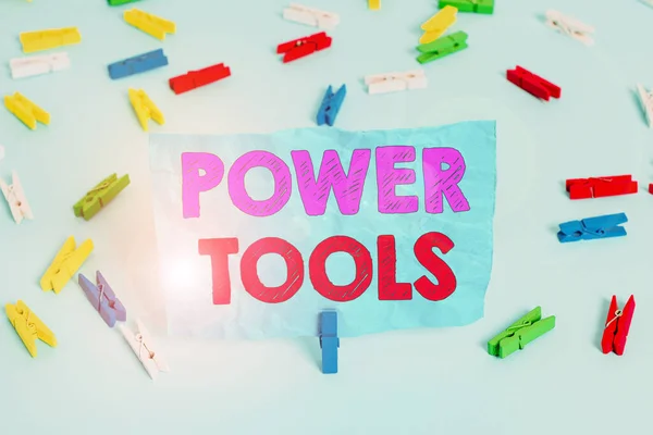 Word writing text Power Tools. Business concept for tool that is actuated by additional power source and mechanism Colored clothespin papers empty reminder blue floor background office pin. — Stockfoto