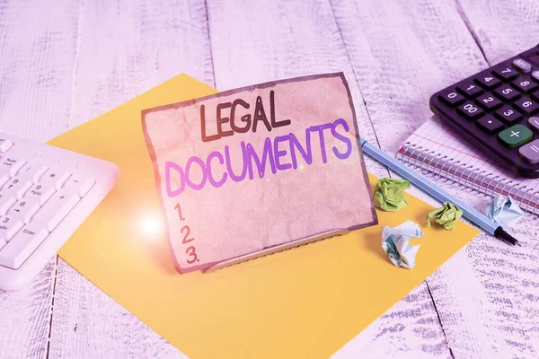 Word writing text Legal Documents. Business concept for a document concerning a legal matter Drawn up by a lawyer Notepaper stand on buffer wire in between computer keyboard and math sheets. — Stock Photo, Image