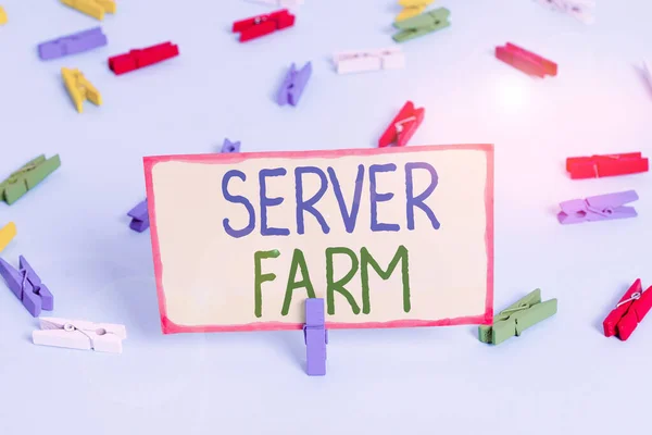 Handwriting text Server Farm. Concept meaning a group of computers acting as servers and housed together Colored clothespin papers empty reminder blue floor background office pin.