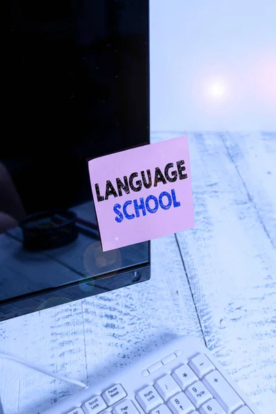 Conceptual hand writing showing Language School. Business photo showcasing educational institution where foreign languages are taught Notation paper computer monitor screen near white keyboard.