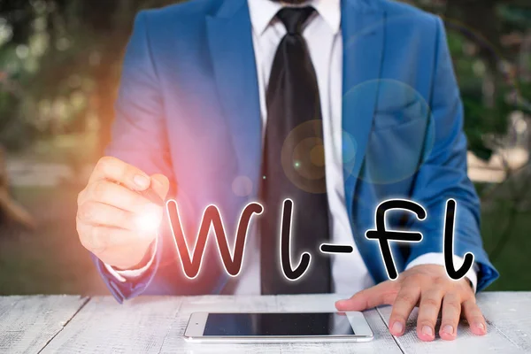 手写体文字写Wi Fi 。概念意思是无线局域网常用的无线电技术。商人将笔尖指向复制空间. — 图库照片