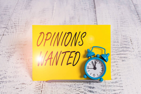 Writing note showing Opinions Wanted. Business photo showcasing judgment or advice by an expert wanted a second opinion Alarm clock tilted above buffer wire in front of notepaper.