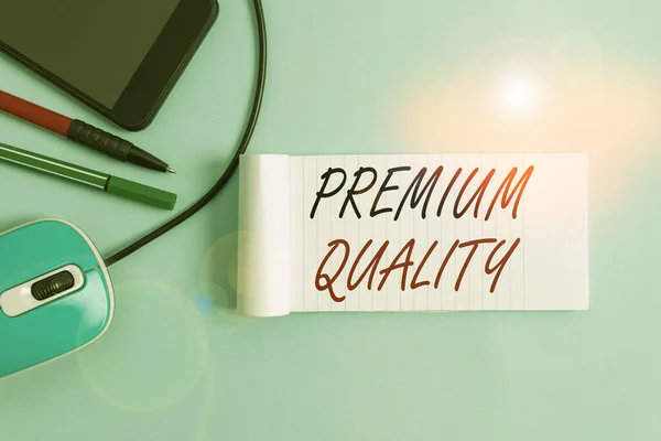 Text sign showing Premium Quality. Conceptual photo something or someone of greater or superior quality Notebook and writing equipment with modern gadget above pastel backdrop. — Stock Photo, Image