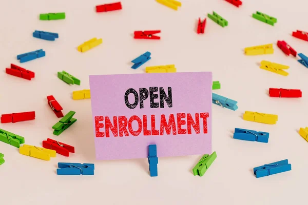 Word writing text Open Enrollment. Business concept for policy of allowing qualifying students to enroll in school Colored clothespin papers empty reminder white floor background office. — Stock Photo, Image