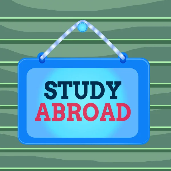 Conceptual hand writing showing Study Abroad. Business photo showcasing live in a foreign country and attend a foreign university Board fixed nail frame colored background rectangle panel. — Stockfoto