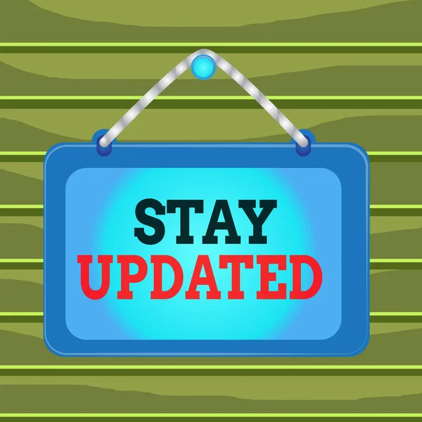 Conceptual hand writing showing Stay Updated. Business photo showcasing keep modern recent or containing the latest information Board fixed nail frame colored background rectangle panel. — Stockfoto