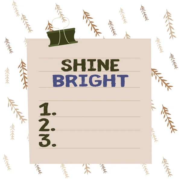 Handwriting text writing Shine Bright. Concept meaning make an effort to live normally when in a difficult situation Paper lines binder clip cardboard blank square notebook color background.