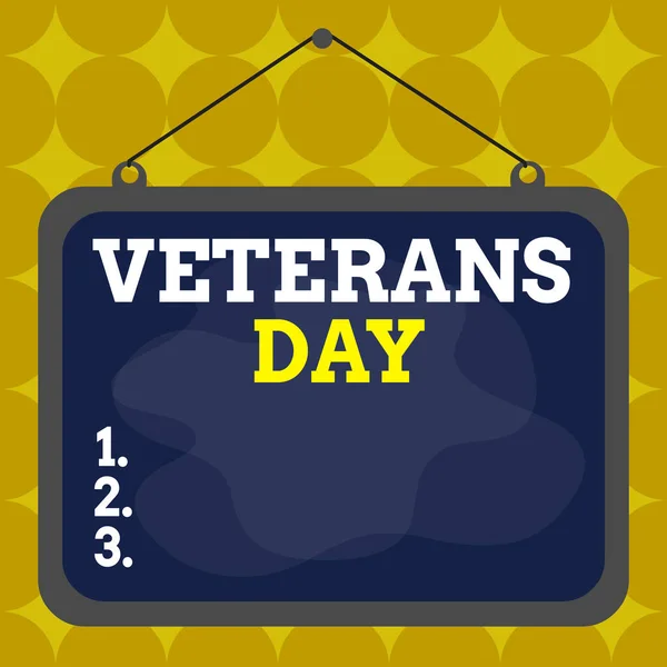 Writing note showing Veterans Day. Business photo showcasing a public holiday to honour US veterans and victims of all wars Asymmetrical uneven shaped pattern object multicolour design.