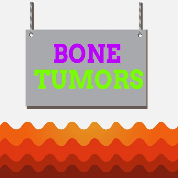 Conceptual hand writing showing Bone Tumors. Business photo text can be either benign or malignant growths found in the bone Wooden board wood empty frame fixed colorful striped string. — Stock fotografie