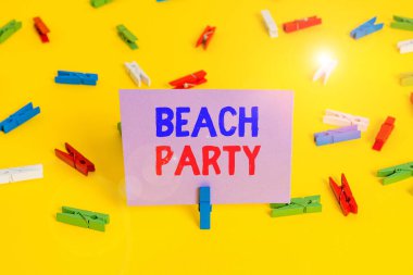 Handwriting text writing Beach Party. Concept meaning large group of showing are organizing an event at the beach Colored clothespin papers empty reminder yellow floor background office.