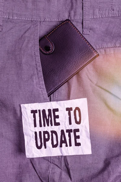 Text sign showing Time To Update. Conceptual photo this is right moment to make something more modern new Small little wallet inside man trousers front pocket near notation paper. — Stock Fotó