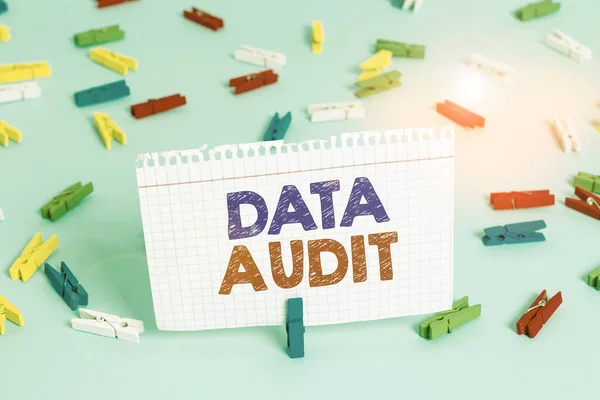 Writing note showing Data Audit. Business photo showcasing auditing of data to assess its quality for a specific purpose Colored clothespin papers empty reminder blue floor officepin. — Stockfoto