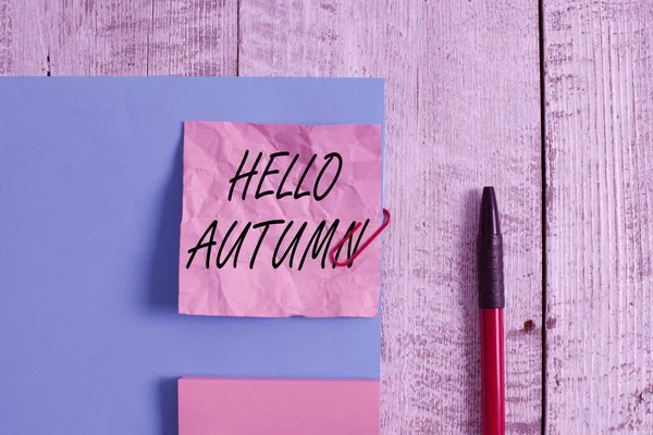 Text sign showing Hello Autumn. Conceptual photo it is the season after summer, when leaves fall from trees Wrinkle paper and cardboard plus stationary placed above wooden background. — Stock fotografie