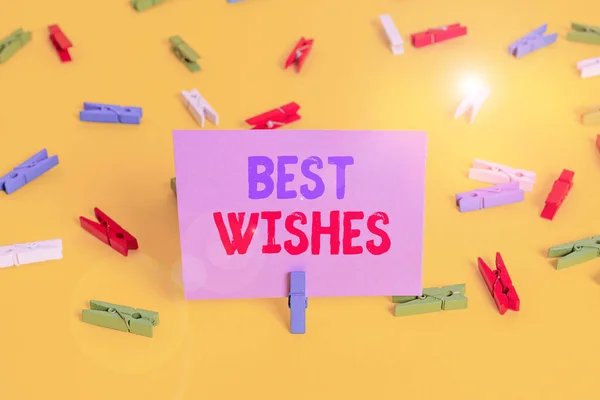 Handwriting text writing Best Wishes. Concept meaning an expression of hope for someone s is future happiness or welfare Colored clothespin papers empty reminder yellow floor background office. — Stockfoto