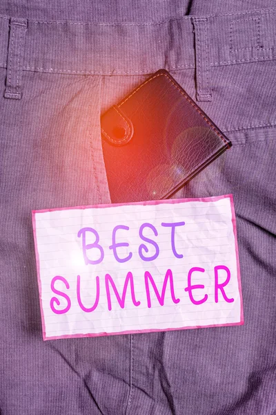 Text sign showing Best Summer. Conceptual photo weather is warmer and many students get a break from school Small little wallet inside man trousers front pocket near notation paper. — Stockfoto