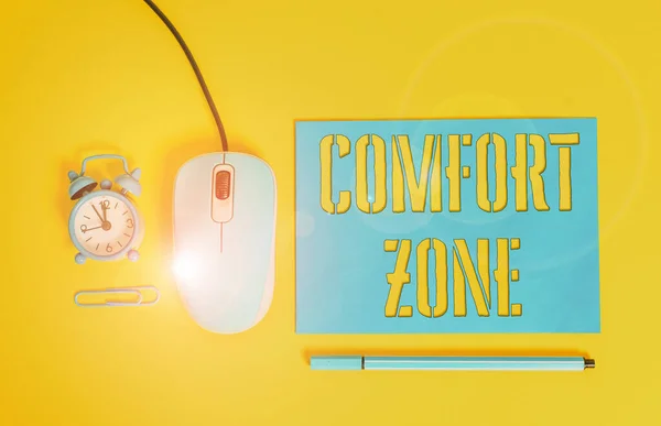 Handwriting text writing Comfort Zone. Concept meaning place or situation where one feels safe and without stress Paper sheet alarm clock clip wire mouse gadget pencil colored background.