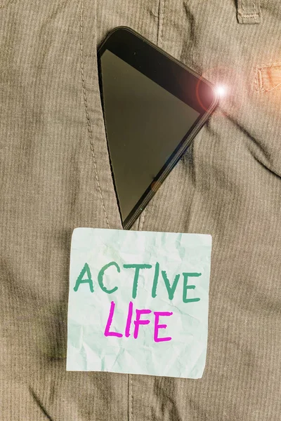 Writing note showing Active Life. Business photo showcasing way of life that integrates physical activity into your everyday Smartphone device inside trousers front pocket note paper.