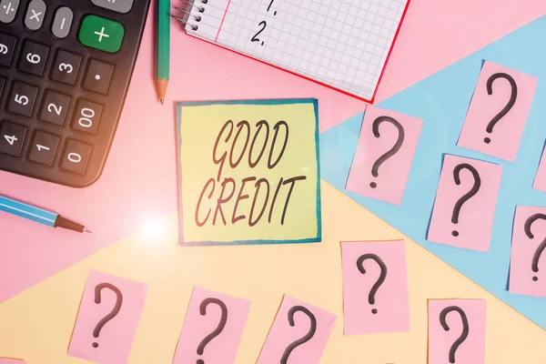 Handwriting text writing Good Credit. Concept meaning borrower has a relatively high credit score and safe credit risk Mathematics stuff and writing equipment above pastel colours background.