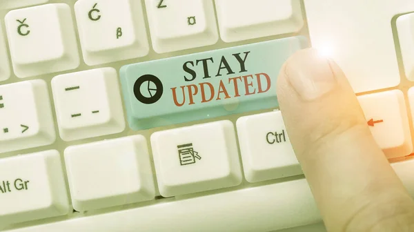 Conceptual hand writing showing Stay Updated. Business photo showcasing keep modern recent or containing the latest information.