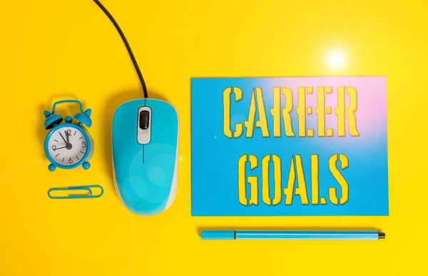 Handwriting text writing Career Goals. Concept meaning profession that an individual intends to pursue in his career Paper sheet alarm clock clip wire mouse gadget pencil colored background.