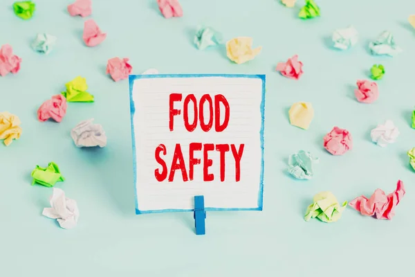 Handwriting text Food Safety. Concept meaning conditions and practices that preserve the quality of food Colored crumpled papers empty reminder blue floor background clothespin. — Stockfoto