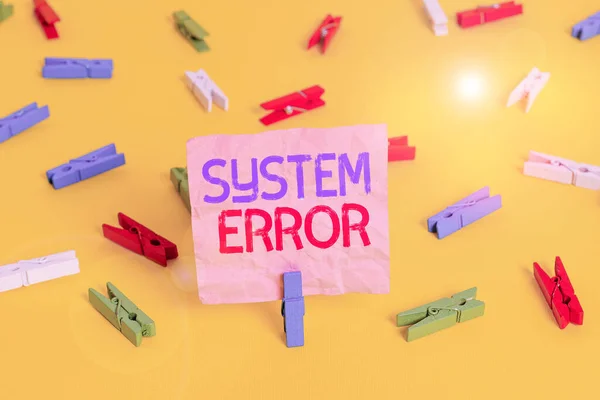 Handwriting text System Error. Concept meaning instruction that is not recognized by an operating system Colored clothespin papers empty reminder yellow floor background office.