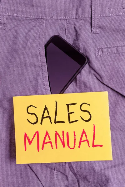 Word writing text Sales Manual. Business concept for set of printed materials containing product descriptions Smartphone device inside formal work trousers front pocket near note paper.
