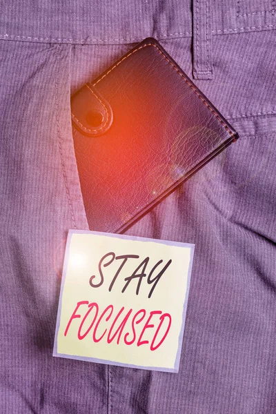 Text sign showing Stay Focused. Conceptual photo direct time and attention to a limited number of issues Small little wallet inside man trousers front pocket near notation paper. — Stock Photo, Image