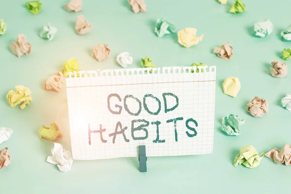 Conceptual hand writing showing Good Habits. Business photo showcasing behaviour that is beneficial to one s is physical or mental health Colored crumpled papers empty reminder blue floor clothespin. — Stock fotografie