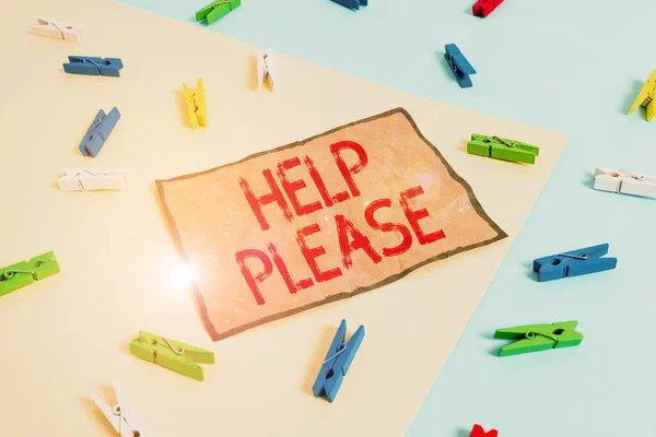 Handwriting text writing Help Please. Concept meaning used to make a request or demand for someone for assistance Colored clothespin paper empty reminder yellow blue floor background office.