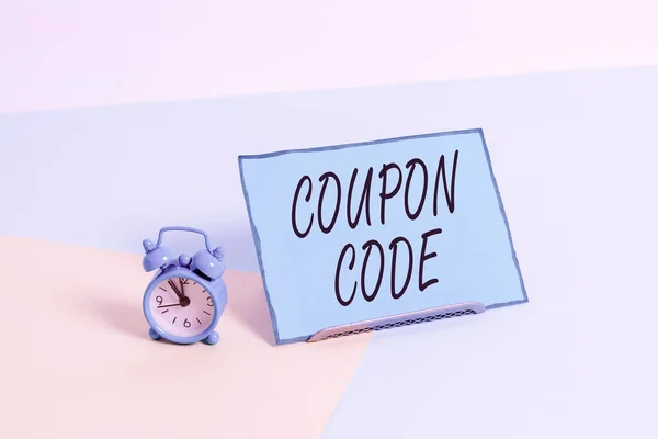 Conceptual hand writing showing Coupon Code. Business photo showcasing ticket or document that can be redeemed for a financial discount Alarm clock beside a Paper sheet placed on pastel backdrop. — Stock Photo, Image