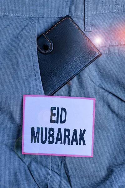 Signo de texto que muestra Eid Mubarak. Foto conceptual saludo musulmán tradicional reservado para los festivales sagrados Cartera pequeña dentro de los pantalones del hombre bolsillo delantero cerca del papel de la notación . — Foto de Stock