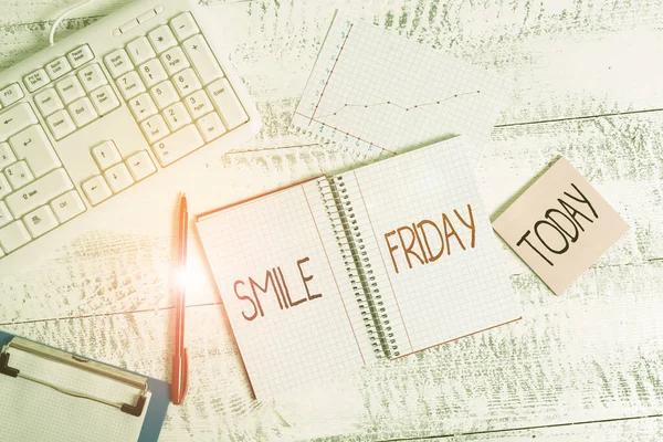 Word writing text Smile Friday. Business concept for used to express happiness from beginning of fresh week Wood desk office appliance computer equipaments chart numbers paper slot. — стокове фото