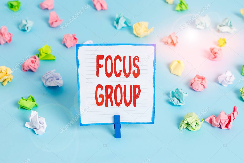 Handwriting text Focus Group. Concept meaning showing assembled to participate in discussion about something Colored crumpled papers empty reminder blue floor background clothespin.