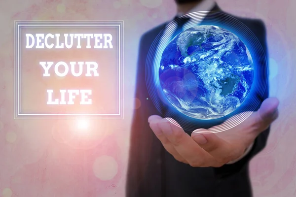 Conceptual hand writing showing Declutter Your Life. Business photo text To eliminate extraneous things or information in life Elements of this image furnished by NASA. — Stock Photo, Image