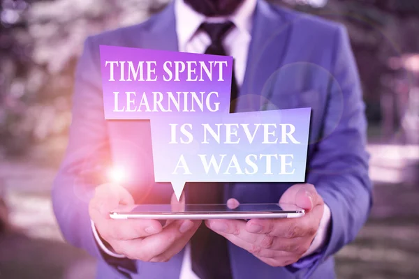 Word writing text Time Spent Learning Is Never A Waste. Business concept for education has no end Keep learning Businessman in blue suite with a tie holds lap top in hands. — Stock Photo, Image