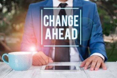 İleride Değişiklik 'i gösteren not yazılıyor. İş fotoğraflarının gösterilmesi ya da farklı olma ya da iş adamı olma durumu ya da önünde parmağıyla işaret etmesi..