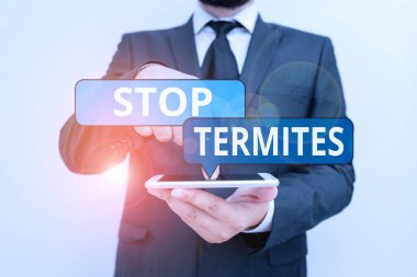 Stop Termitleri gösteren kavramsal el yazısı. İş fotoğrafçılığı küçük bir tropikal böceğin ormana zarar vermesini engelliyor. Erkek insan resmi iş kıyafeti giyiyor. Akıllı telefonu kullan..