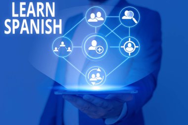 Writing note showing Learn Spanish. Business photo showcasing gain or acquire knowledge of speaking and writing Spanish.