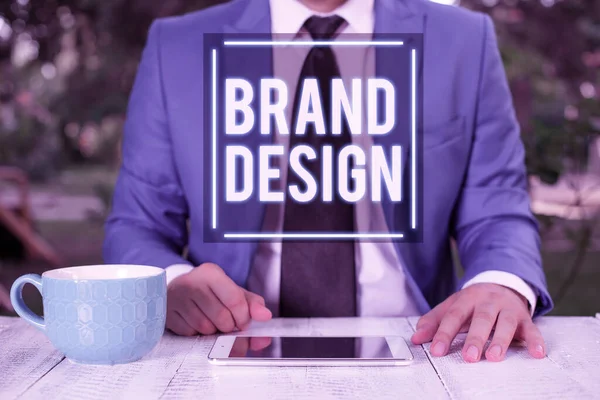 Writing note showing Brand Design. Business photo showcasing visual elements that make up the corporate or brand identity Businessman with pointing finger in front of him.