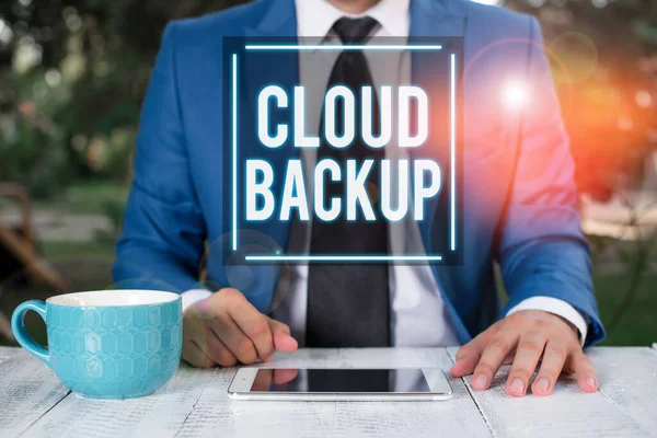 Writing note showing Cloud Backup. Business photo showcasing enable customers to remotely access the provider s is services Businessman with pointing finger in front of him.