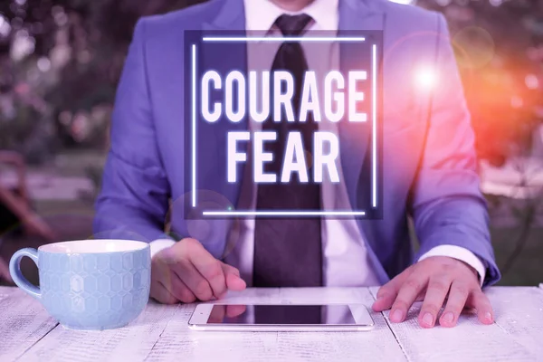 Writing note showing Courage Fear. Business photo showcasing quality of mind that enables a demonstrating to face difficulty Businessman with pointing finger in front of him.