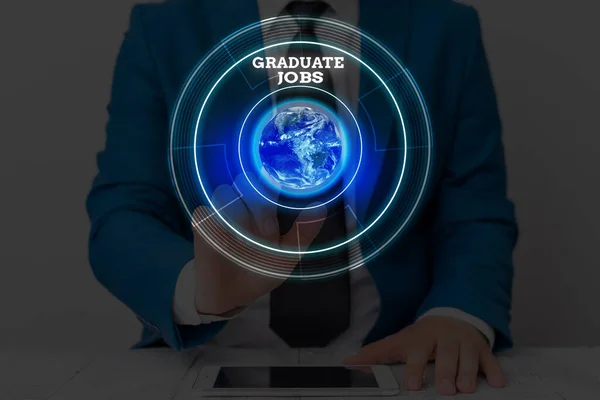 Text sign showing Graduate Jobs. Conceptual photo require someone to hold a degree to start their career Elements of this image furnished by NASA.