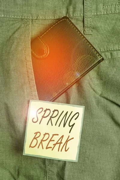 Text sign showing Spring Break. Conceptual photo week s is vacation for students in the spring typically at Easter Small little wallet inside man trousers front pocket near notation paper. — Stock Photo, Image