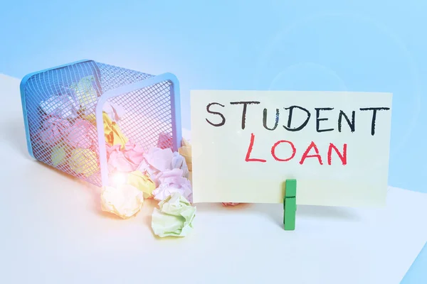 Handwriting text writing Student Loan. Concept meaning financial assistance designed to help students pay for school Trash bin crumpled paper clothespin empty reminder office supplies tipped.
