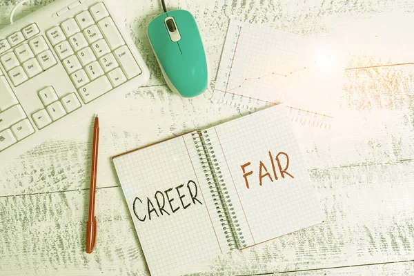 Text sign showing Career Fair. Conceptual photo an event at which job seekers can meet possible employers Wood desk office appliance computer equipaments chart numbers paper slot.