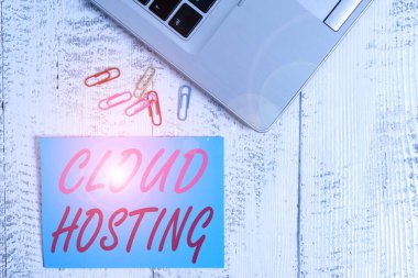 Bulut sunuculuğunu gösteren bir not yazıyorum. Tek sunucularda web sitelerinin sunulmasına alternatif iş fotoğrafı gösteriliyor. Moda metalik dizüstü bilgisayar boş yapışkan not klipleri klasik tablo üzerinde.