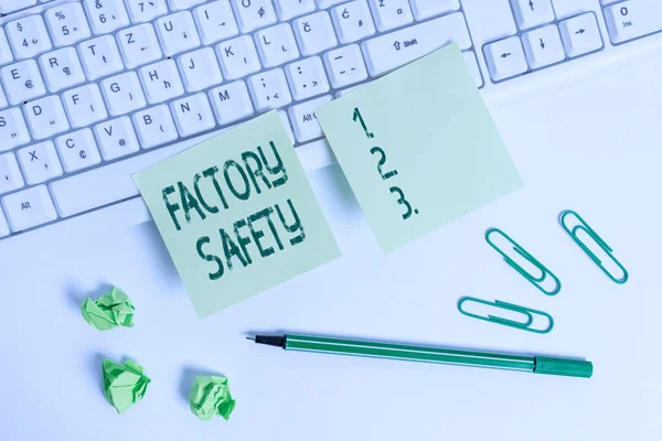 Handwriting text writing Factory Safety. Concept meaning minimize risk of worker injury while doing production tasks Square green note paper with pencil on the white background.