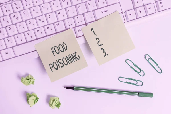Handwriting text writing Food Poisoning. Concept meaning the illness caused by bacteria or other toxins in food Square green note paper with pencil on the white background.