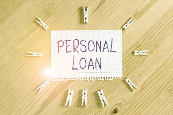Conceptual hand writing showing Personal Loan. Business photo showcasing unsecured loan taken by individuals from a financial company Colored crumpled papers wooden floor background clothespin. — Stock Photo, Image